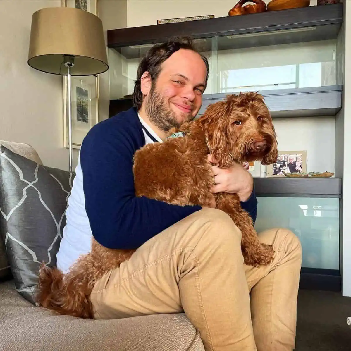 owner cuddles with Labradoodle