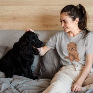 woman and her dog sitting on a bed