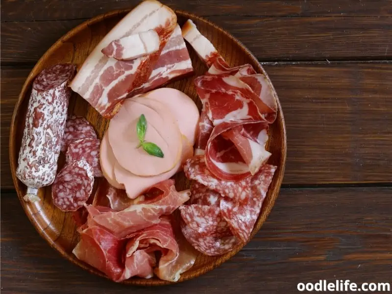 deli meats on a wooden plate