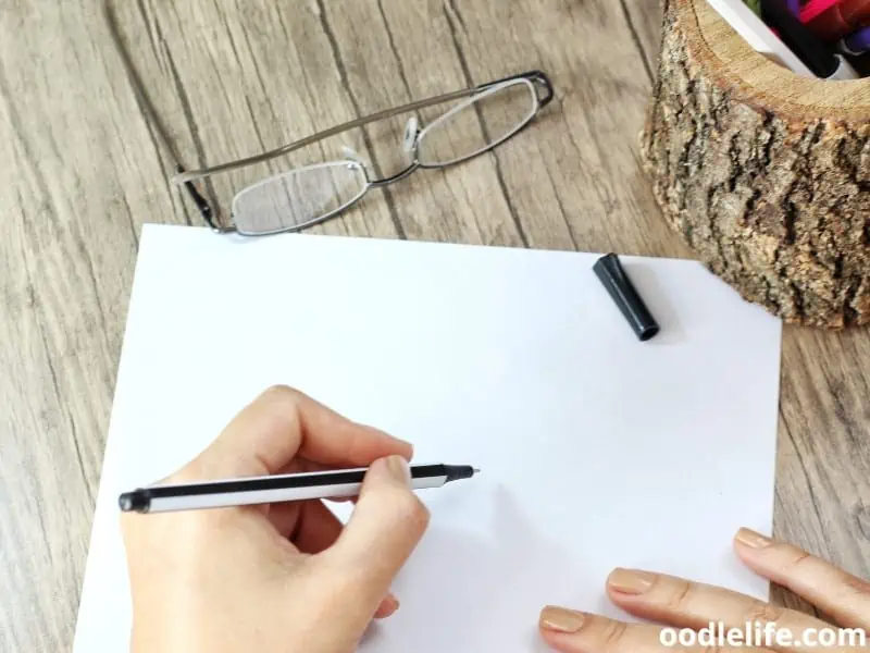 woman holds a pen