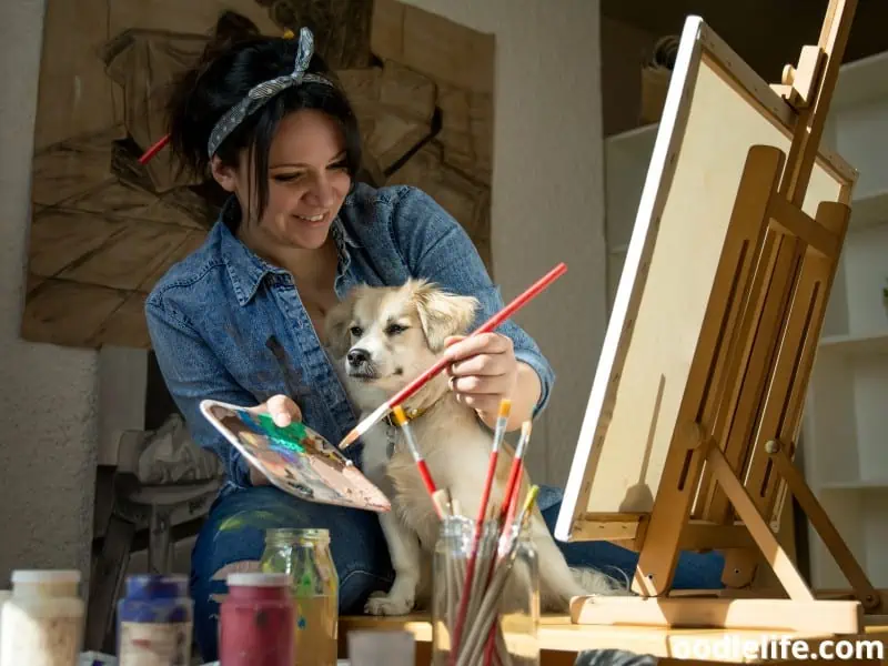 owner paints with her dog